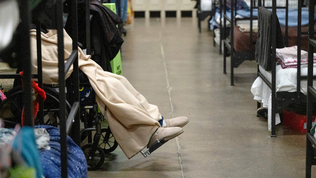An elderly woman sits in a wheelchair at the county’s low-barrier shelter at the Salvation Army Berberian Center in Modesto, Calif., Wednesday, Nov. 22, 2023.