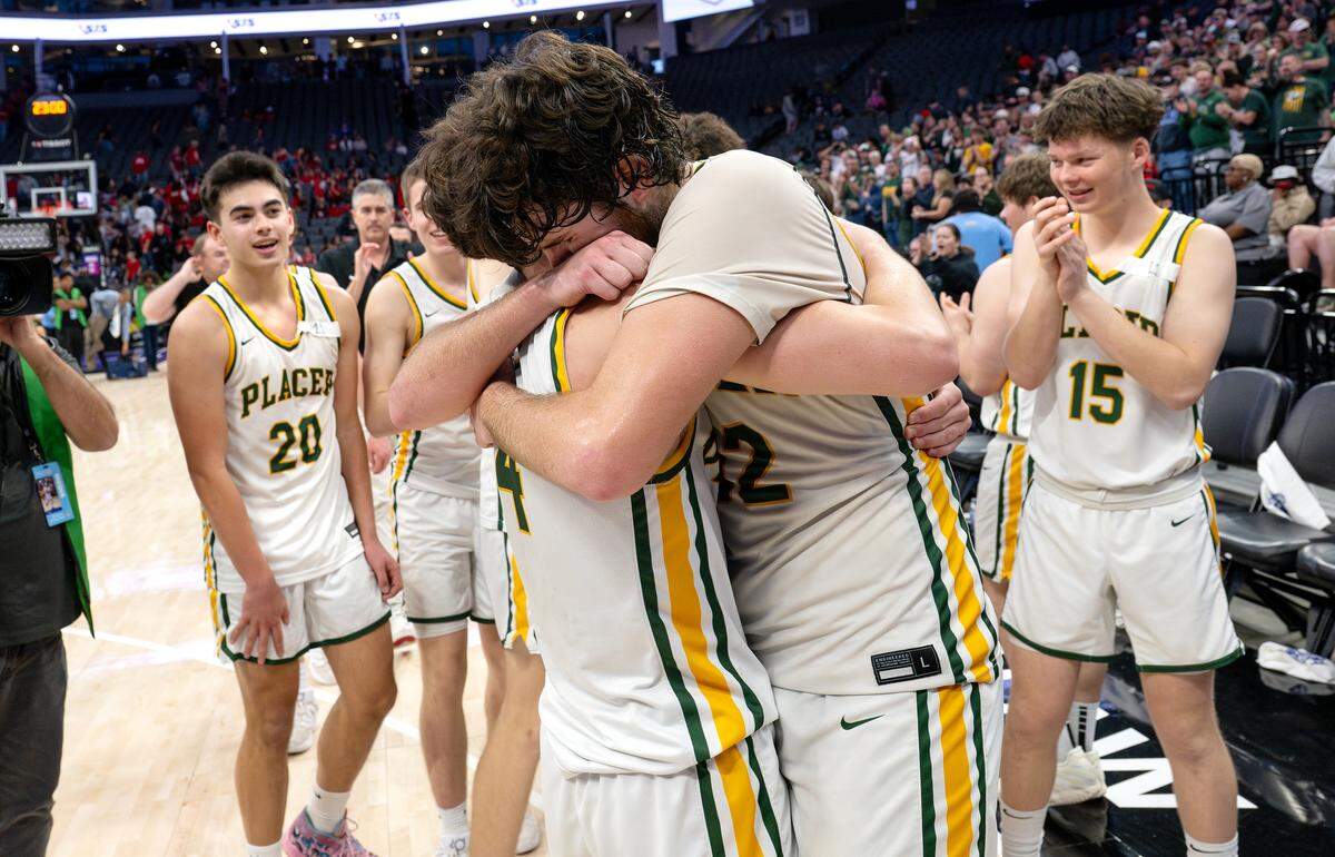 Placer players Kannon Rector and Jeremiah Rethi (4) hug after winning the Sac-Joaquin Section Division III championship game over Beyer at the Golden 1 Center in Sacramento on Saturday.
