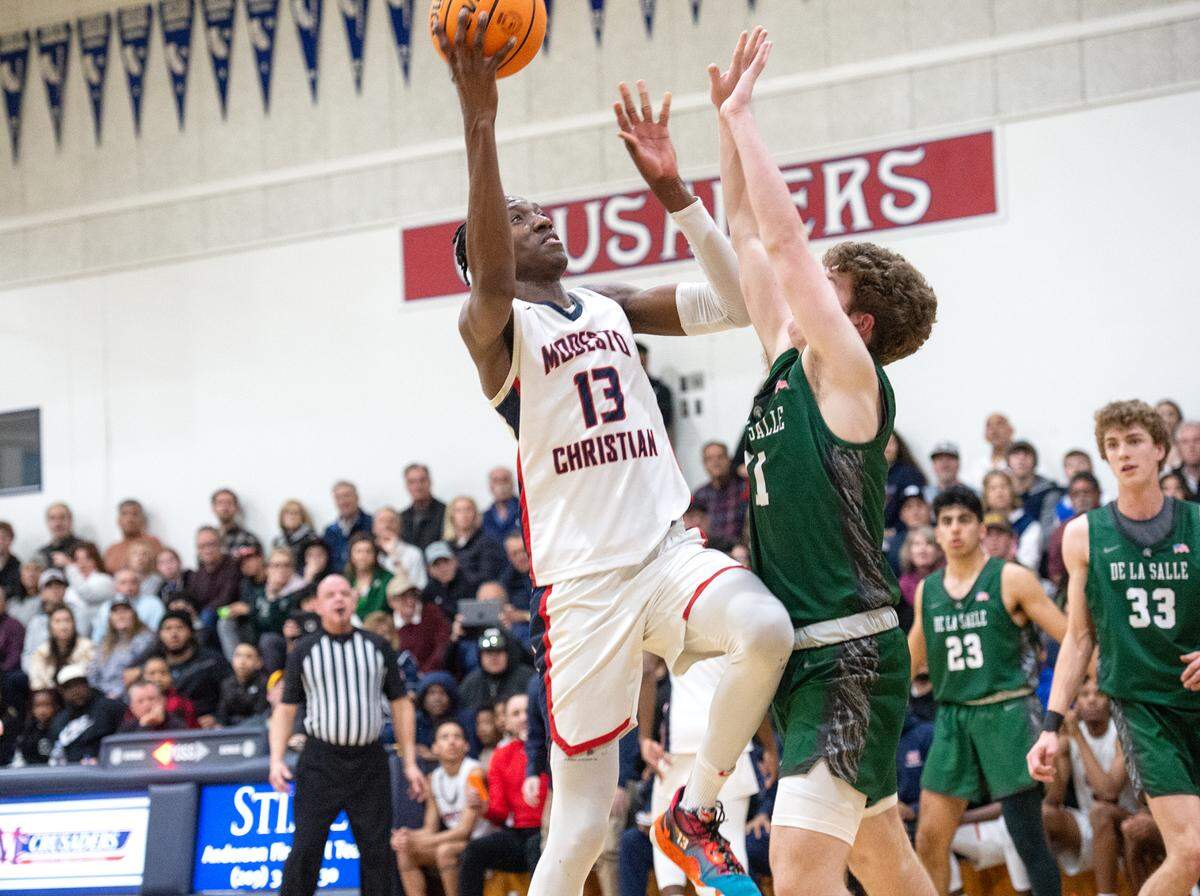 Modesto Christian’s Prince Oseya, scores over De La Salle’s Matt Daly during the NorCal Open Division semifinal playoff game in Salida, Calif., Saturday, March 4, 2023.