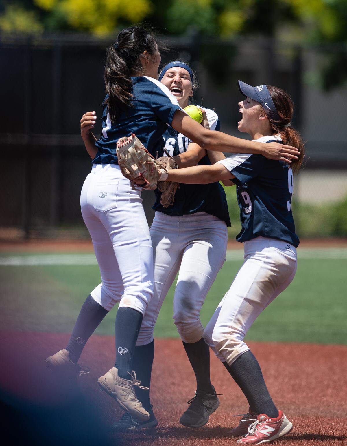 Vista del Lago players Charlize Cai, Tayler Biehl and Allison Morrissey celebrates the final out of the CIF Sac-Joaquin Section Division III softball championship game with Central Catholic at Delta College in Stockton, Calif., on Saturday, May 28, 2022. Vista won the game 7-5.