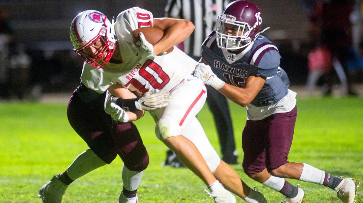 Ripon receiver Troy Brogan (10) powers through two Central Valley defenders to score a touchdown during a game between Ripon High School and Central Valley High School at Ceres High School in Ceres California on September 6, 2019.