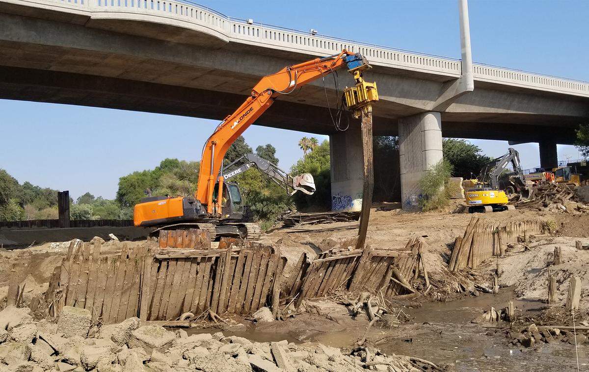 Crews work to remove Dennett Dam on Tuesday August 21, 2018 near the Ninth street bridge in Modesto, Calif.