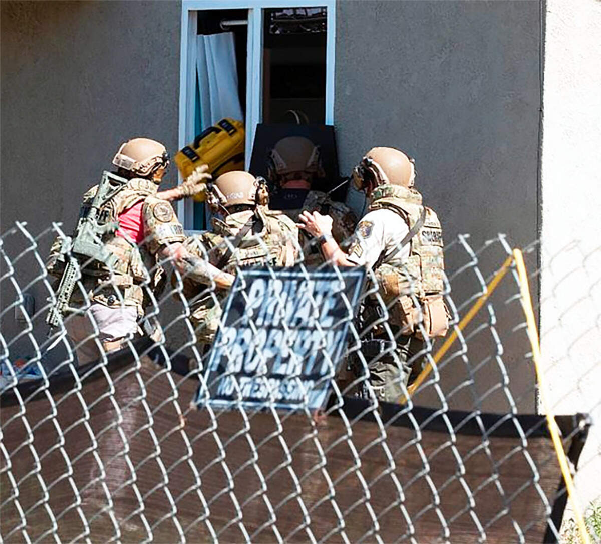 The Stanislaus County Sheriff’s Department SWAT team converges on a home in the 200 block of Olivero Road in Modesto, California, during a hostage situation that led to the fatal shooting of suspect Jose Astorga Jr., 37, of Modesto. Deputy Fernando Gomez, a three-year member of the department, shot Astorga, which led to the rescue of the victim.