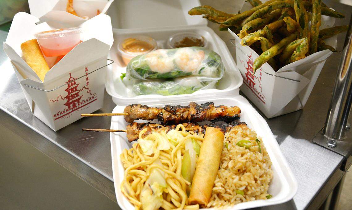 A combination plate with chicken skewers, egg rolls, spring rolls, fried shrimp and fried green beans from the new Southeast Asia Grill takeout restaurant on Tully Road in Modesto, Calif. Sept. 17, 2021.