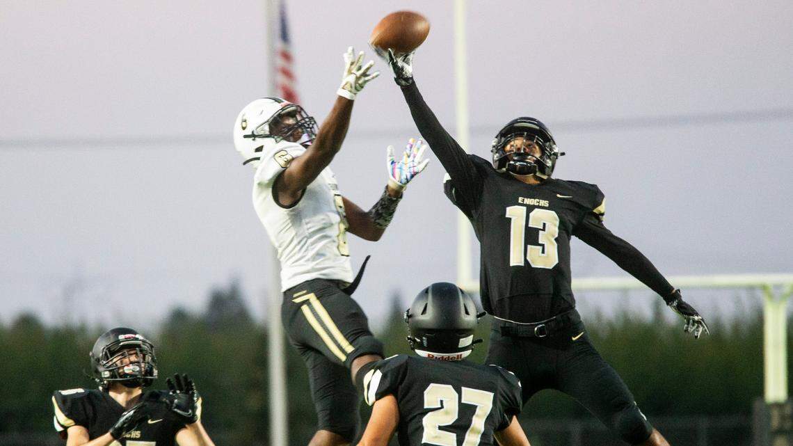 Jordan Colbert, 6, of Buhach Colony goes for his pass only to be block and intercepted by Isaiah Toma, 13, of Enochs High. Enochs High vs Buhach Colony football at Johansen Friday, Sept. 3, 2021.
