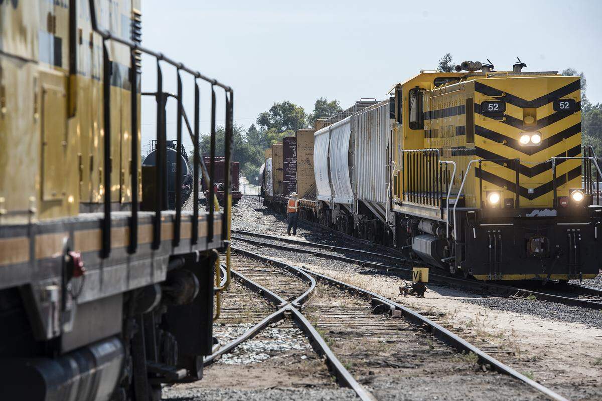A train crew moves cars along the Sierra Northern Railway in Oakdale, Calif., Friday, June 14, 2019.