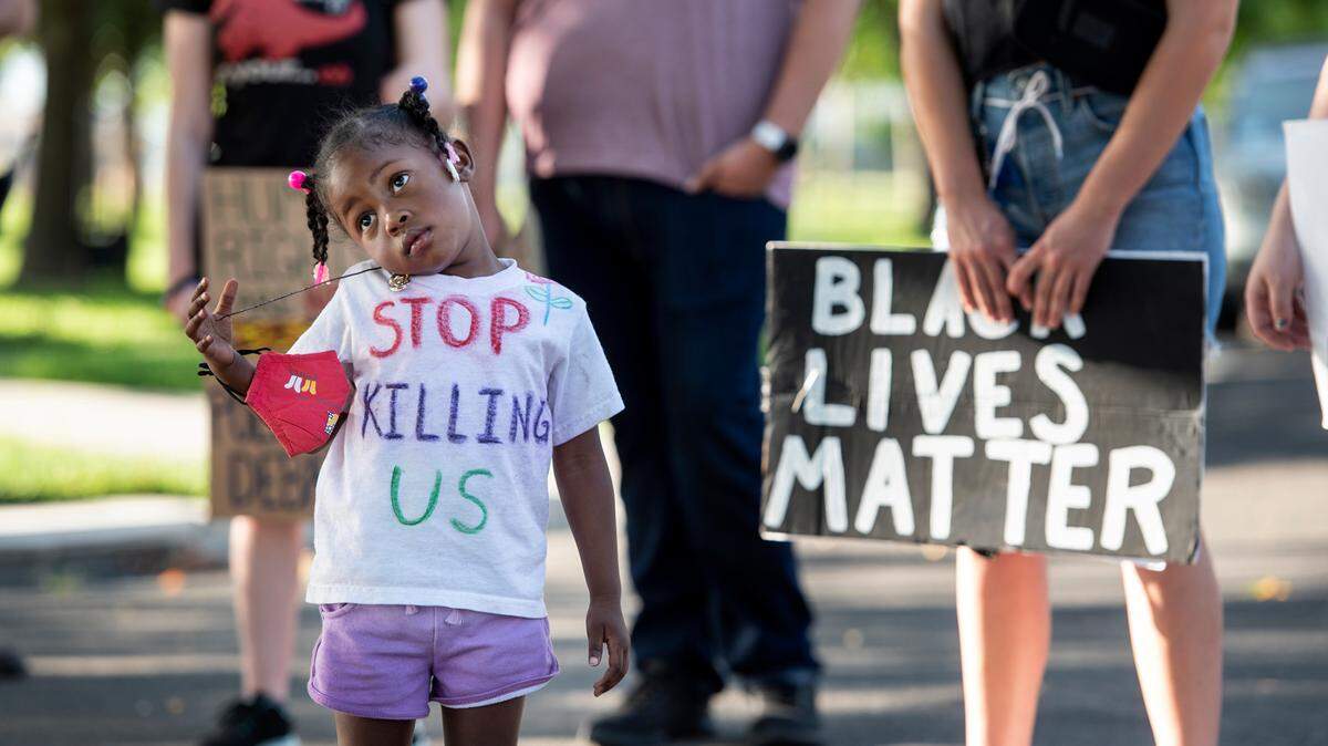 Nai’lah Brenda, 3, listens during a Black Lives Matter gathering in Turlock last June.