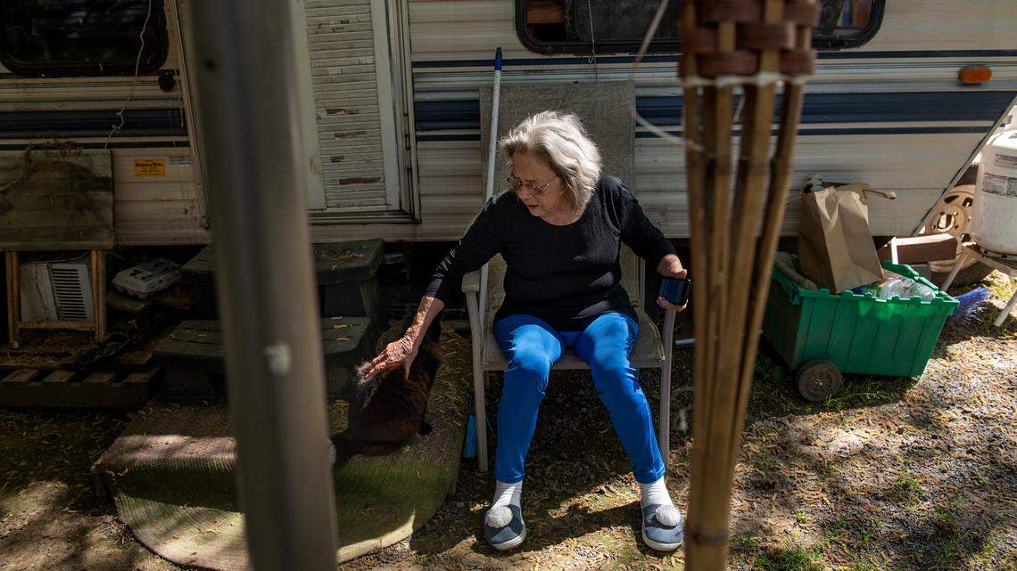 Rita Gwin pets her cat Boo at River’s Edge RV Park and Campgrounds in Knights Ferry, Calif., on Friday, April 16, 2021. Residents, many who are retirees and disabled people, pay monthly rent on fixed incomes.