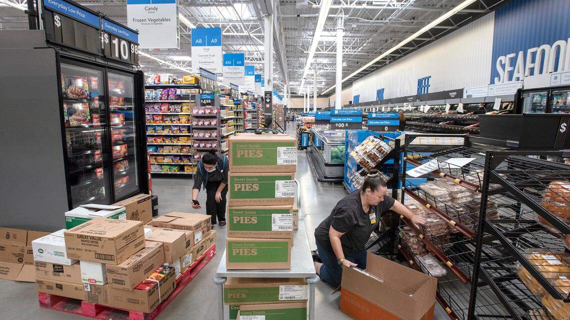 Paula Berg, right, helps stock the bakery department at the Walmart Supercenter in Ceres ,Calif., part of the larger Modesto metropolitan area, on Wednesday, Nov. 17, 2021.