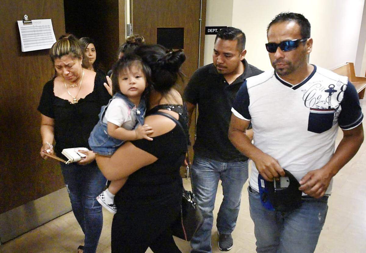 Family members of Mari Luz Jacinto-Hernandez, including husband Jorge Sanchez, right, leave the arraignment of Felix Ferdin at Stanislaus Superior Court in Modesto, Calif., Tuesday, June 11, 2019. Ferdin was arraigned after he allegedly drove a car into a house, killing Jacinto-Hernandez and her two little girls.