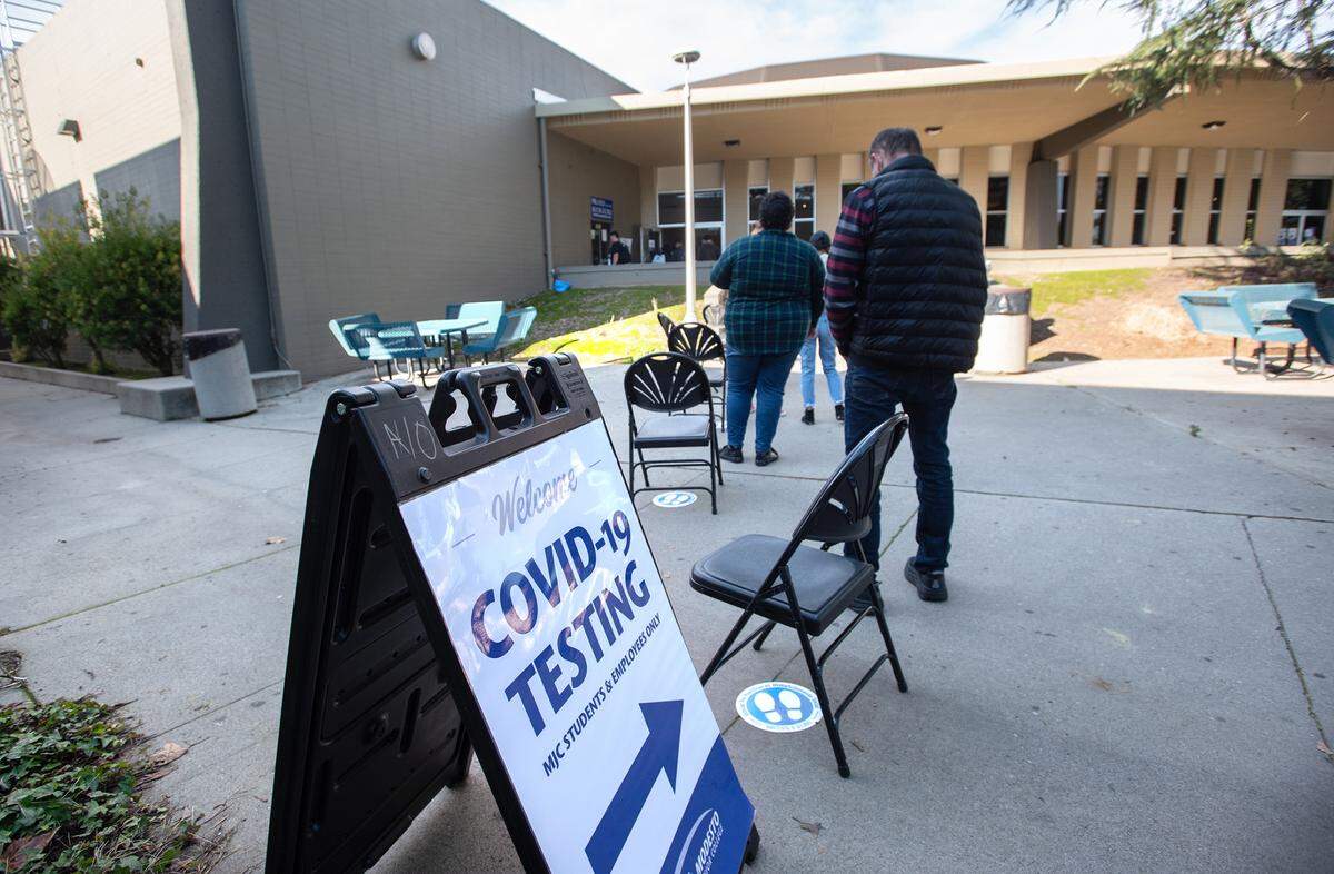 Students line up for required Covid-19 test at Modesto Junior College east campus in Modesto, Calif., on Tuesday, Jan. 11, 2022.
