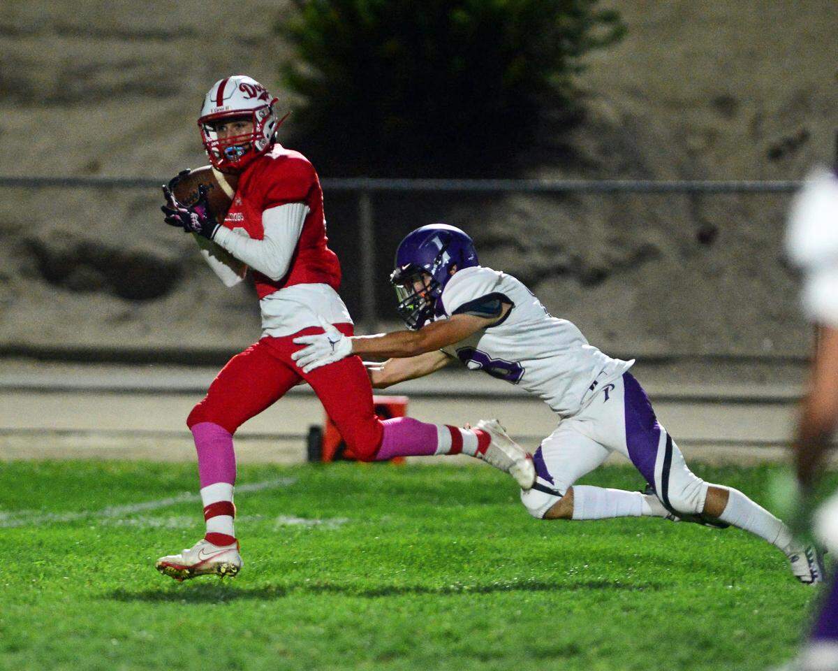 Ceres receiver Manuel Mandoza makes a deep catch over the middle during a game between Ceres High School and Pacheco High School at Ceres High School in Ceres California on October 7, 2022.
