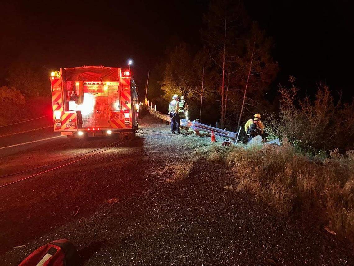Emergency crews work along New Priest Grade after a vehicle went over the side of the roadway, prompting a technical rescue and airlift of two injured patients.