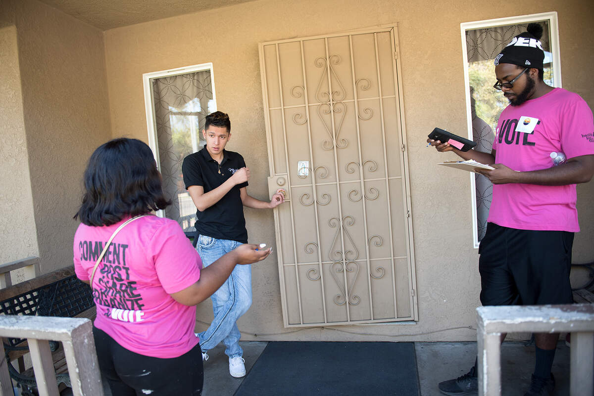 Volunteers from Faith in the Valley Ambriana Williams, left, and her husband AAron Williams talk with Efrain Garcia about Propositions 10 and 5 in Modesto, Calif., on Saturday, Oct. 13, 2018. Volunteers from Faith in the Valley canvassed the west Modesto neighborhood in advance of the November election.