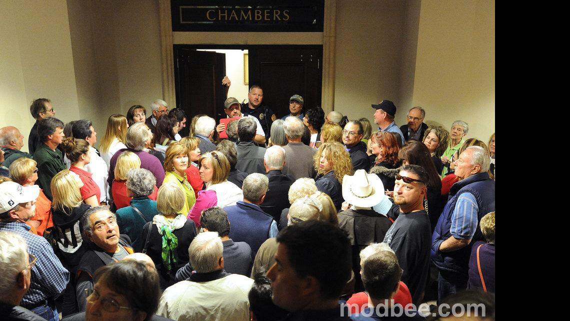 Modesto police officer John Wohler informs a large group of Wood Colony supporters, that they might not all fit into the city council chambers in the basement of downtown's Tenth Street Place prior to Tuesday night's (01-28-14) city council meeting regarding the inclusion of the Wood Colony area in the city's general plan.