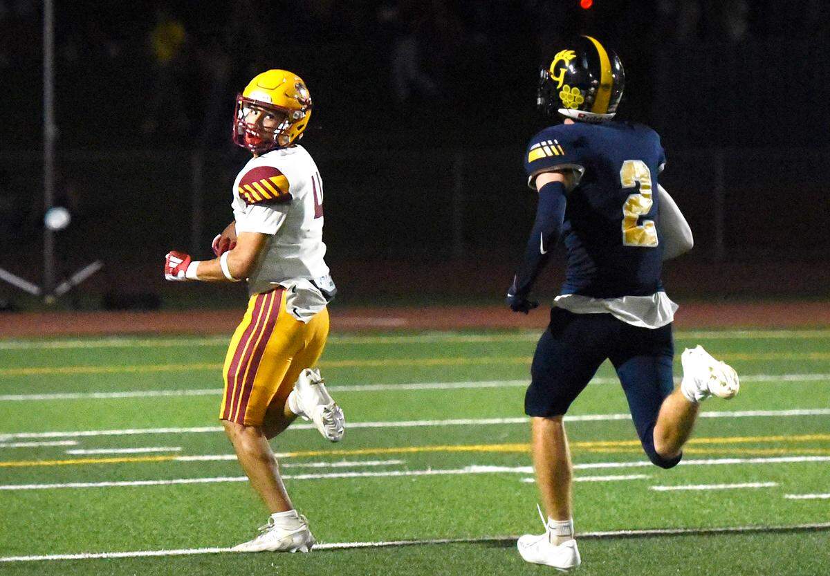 Los Banos senior WR Joshua Gargano looks back at a defender while scoring on a 55-yard TD reception during the game with Gregori in Modesto, Friday, Sept. 19, 2025. 