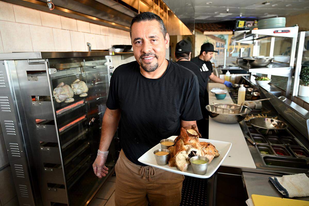 Chef Abel Casillas with pollo a la brasa, Peru’s signature blackened rotisserie chicken at Las Uvas Restaurant in Modesto, Calif., Thursday, Oct. 5, 2023.