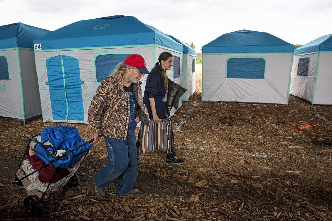 Jeff Lossing and Vickie Dupire relocate from Beard Brook Park to the new Modesto Outdoor Emergency Shelter for the homeless under the Ninth Street Bridge in Modesto, Calif., Wednesday, Feb. 20, 2019.
