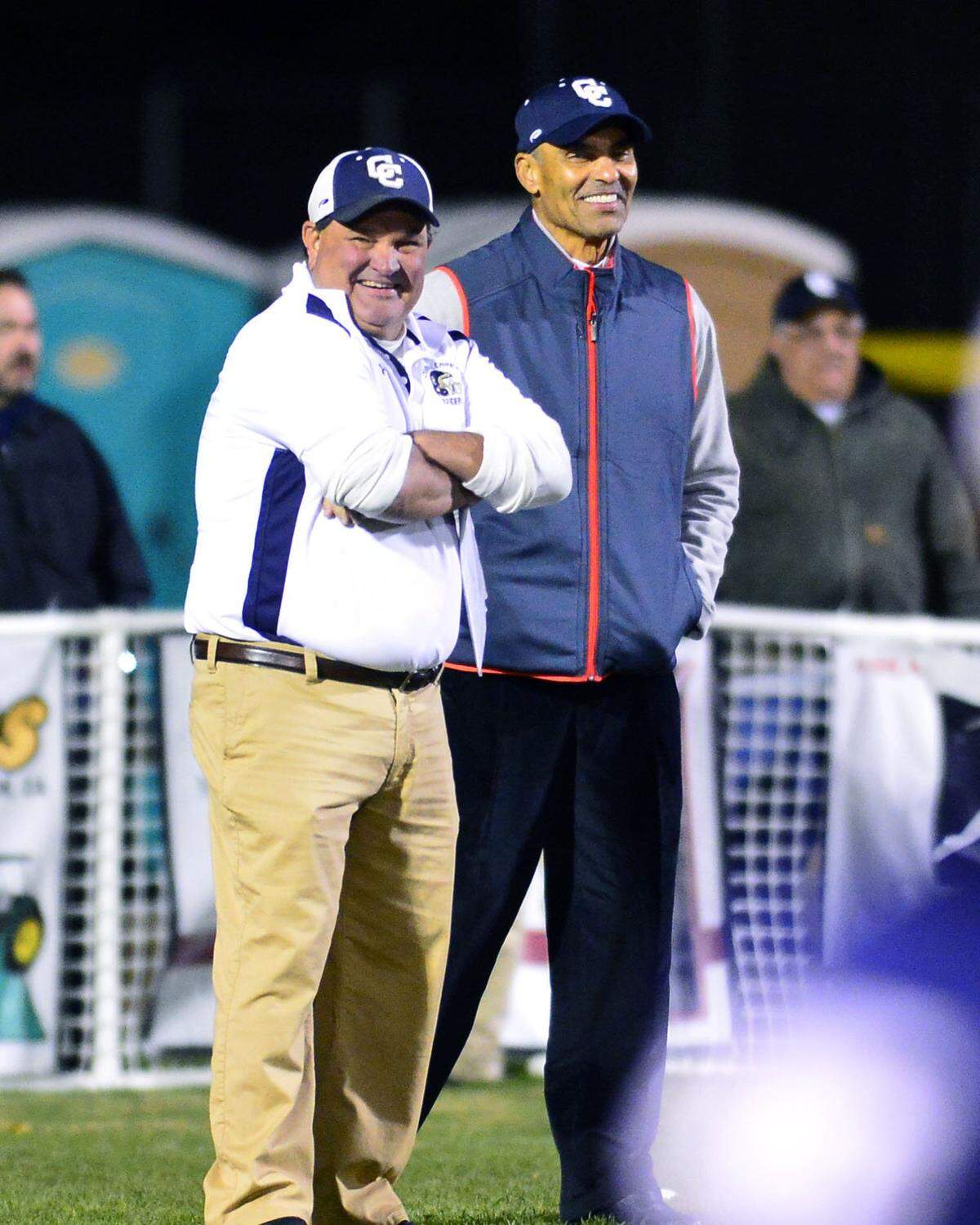 Herm Edwards (right) and Central Catholic head coach Roger Canepa (left) share a laugh before a game between Central Catholic and Placer in Modesto California on Nov. 27, 2015.