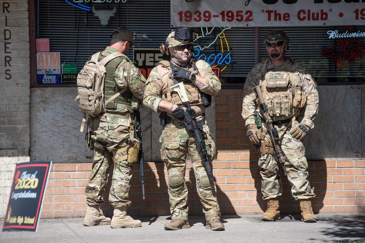 Members of the California State Militia stand outside the H-B Saloon on Highway 120 in Oakdale, Calif., on Saturday, June 6, 2020.