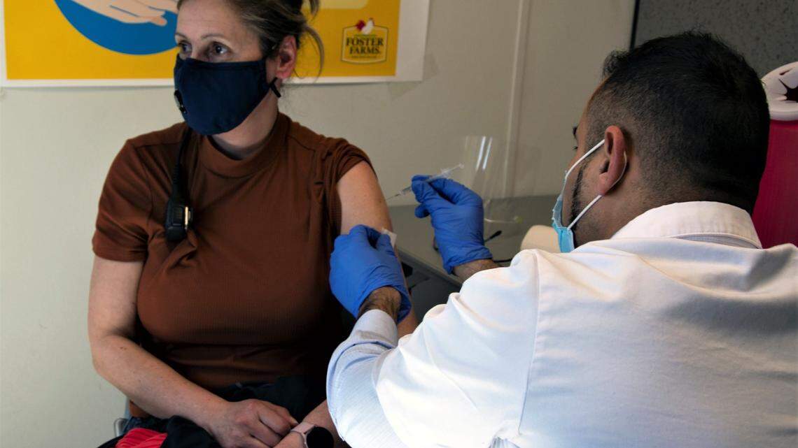 Maria Ouse receives a vaccine shot on March 2, 2021.