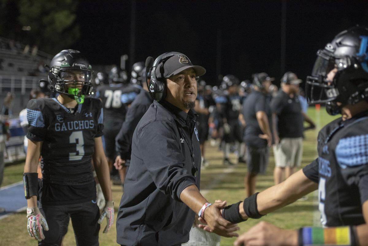 El Capitan head coach Xavier Ramirez congratulates a player on the sideline during Friday’s CIF Sac-Joaquin Section Bowl against Livingston. The Gauchos closed their season with a 22-8 win at Stadium 76 in Merced.