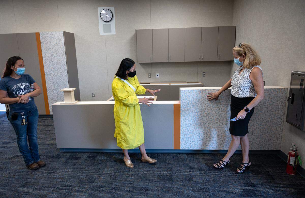 Head Custodian Dawn Ward, left, and Bret Harte principal Marla Conteh, middle, talk with Modesto City Schools Superintendent Dr. Sara Noguchi, right, during a tour of the school as part of a larger look at facility projects funded by bond and district money in Modesto, Calif., on Monday, Aug. 2, 2021. School leaders gave a tour of construction projects at eight elementary, middle and high schools. Renovations included new classrooms, cafeterias, and parking lots.