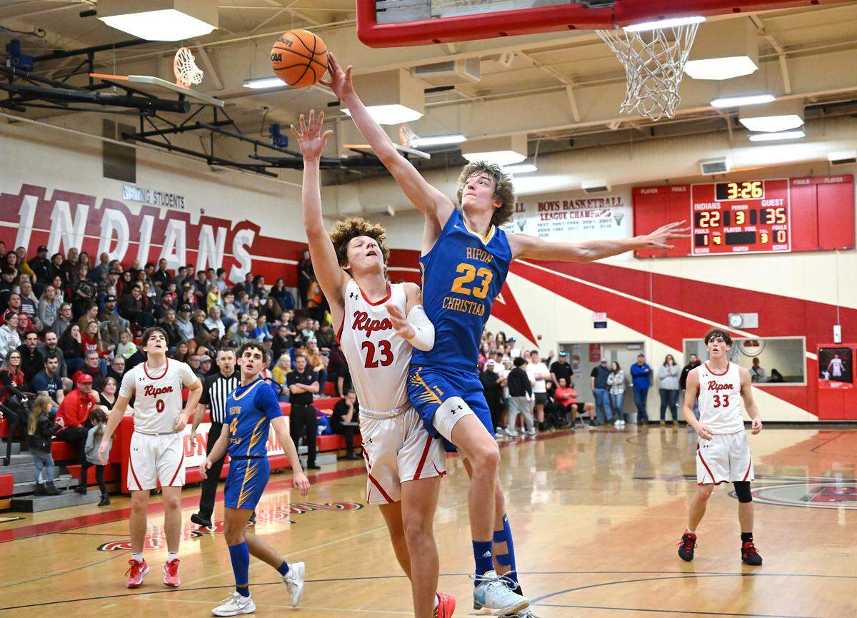 Ripon Christian’s Jace Beidleman blocks the shot of Ripon’s Dawson Downs during the Trans Valley League game in Ripon, Calif., Friday, Feb. 9, 2024. Ripon Christian won the game 54-42.