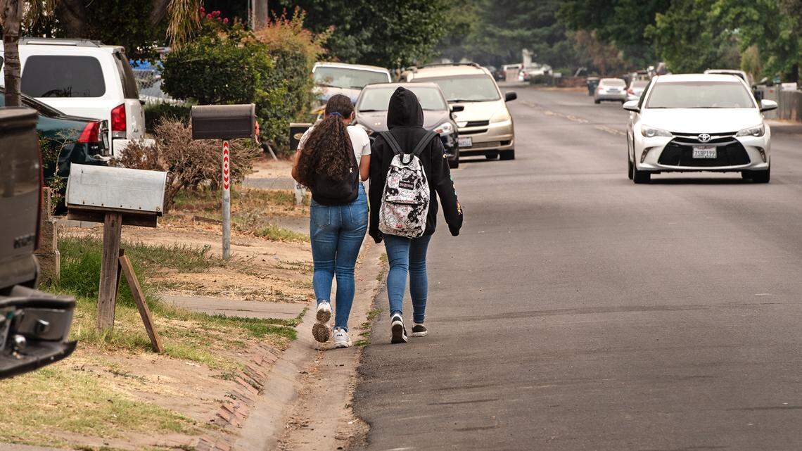 Teens walk down Rouse Avenue in Modesto, Calif., on Friday, Aug. 6, 2021.