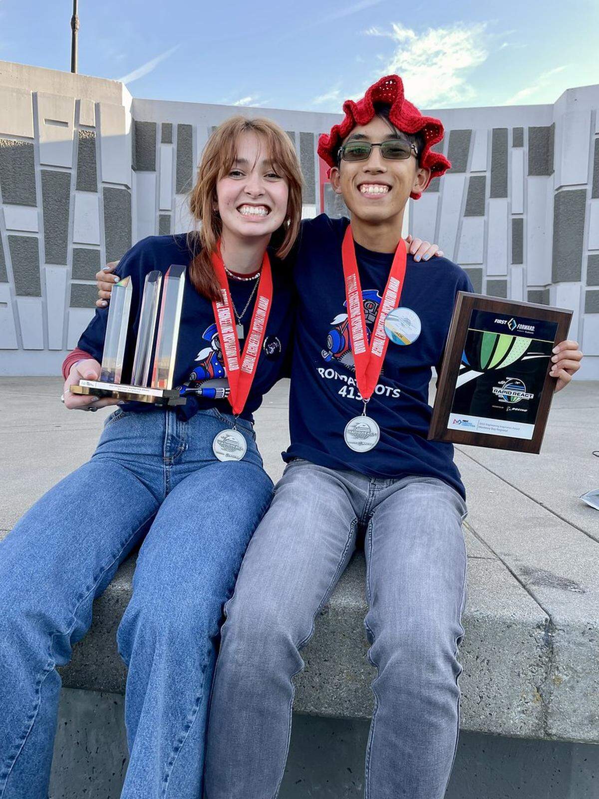 Beyer High School student co-captains Gracie Maldonado Roberts and Tahbert Bui pose with awards their Iron Patriots robotics team won for Engineering Inspiration.