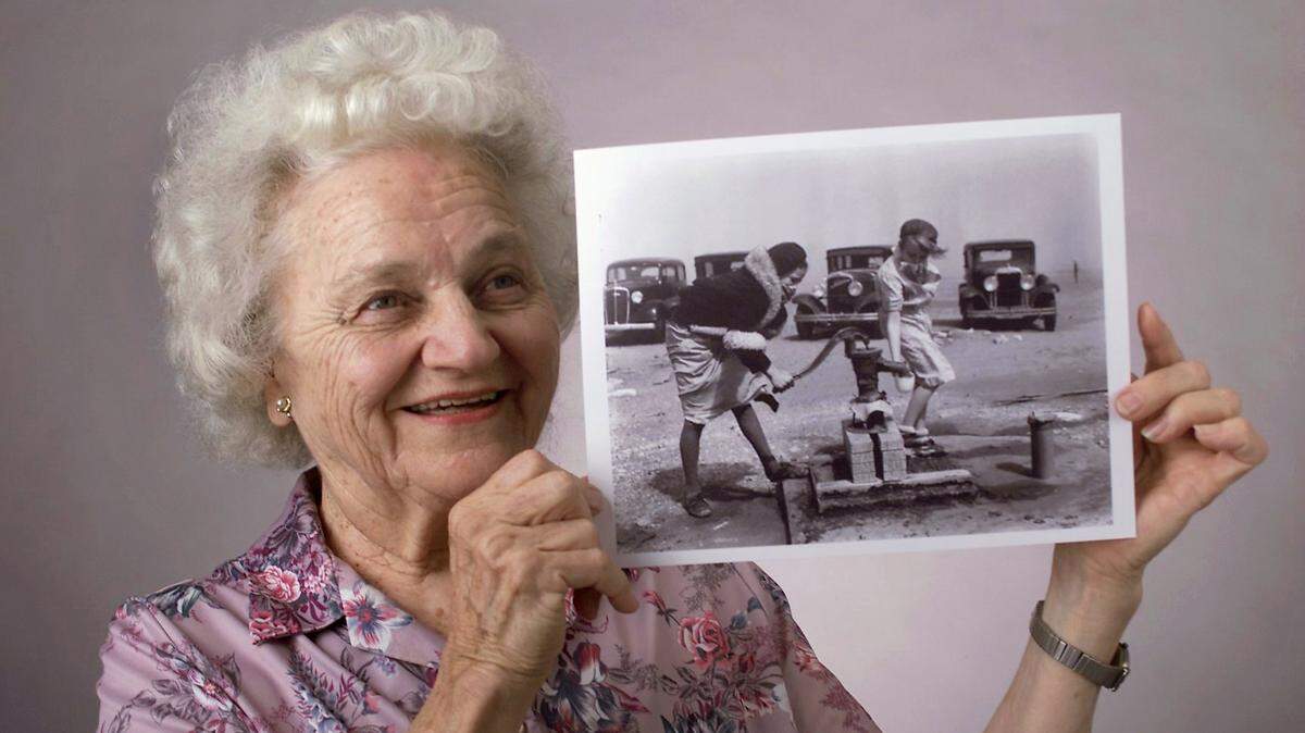 Ada Jones, 81, holds a photo of herself (she’s on the left in the image) when she was 13 years old and a friend during the Dust bowl.