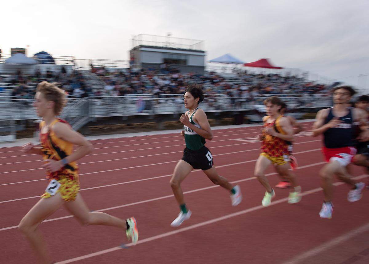 Pitman’s Damian Garcia, middle, won the boys 1,600-meter race at the Stanislaus County Championships on Friday, March 18, 2022, at Riverbank High School in Riverbank, Calif.