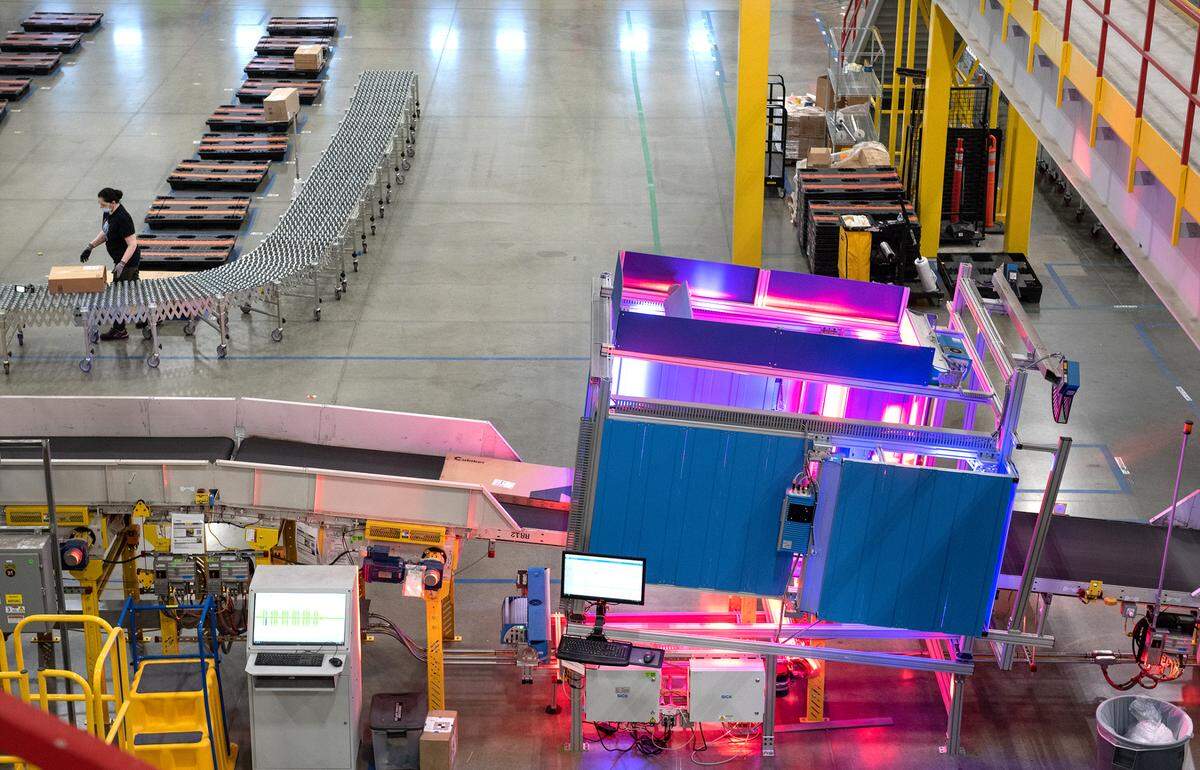 A six-sided scanner helps route large packages at the Amazon robotic sort center in Tracy, Calif., Thursday, Nov. 10, 2022.