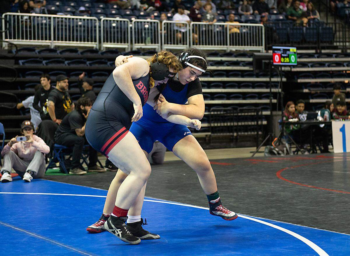 Salana Camacho of Beyer (blue) battles with Emma Ford of Bella Vista in the 235-pound third-place match during the CIF Sac-Joaquin Section Masters wrestling tournament at the Stockton Arena in Stockton, Calif., on Saturday, Feb. 19, 2022. Camacho took third with a pin of Ford.