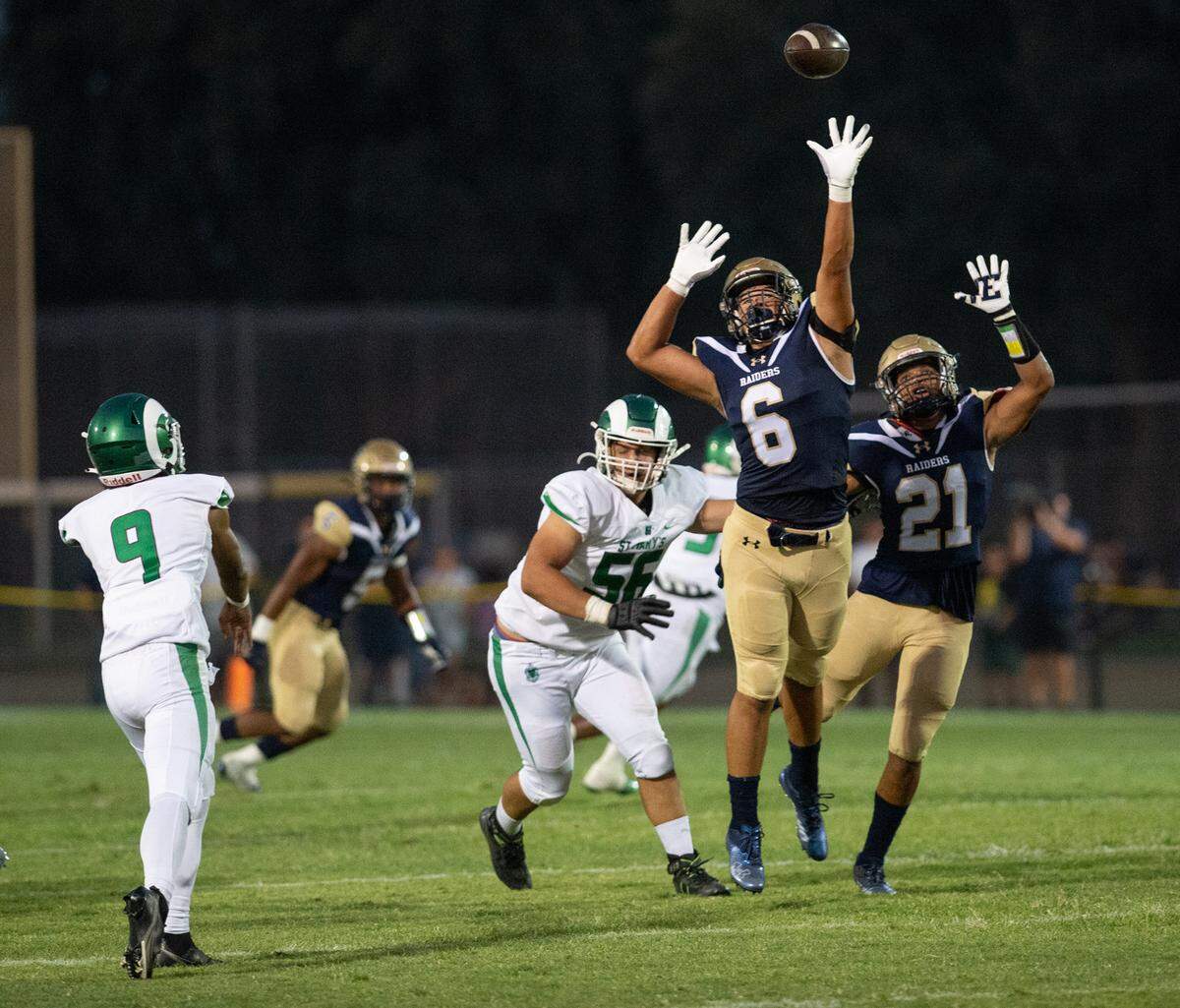 St. Mary’s quarterback Samson Hunkin, throws the ball over Central Catholic’s Mario Savala III (6) and Joel Roberts (21) during the non-league game at Central Catholic High School in Modesto, Calif., on Friday, September 2, 2022. St. Mary’s won the game 47-7.