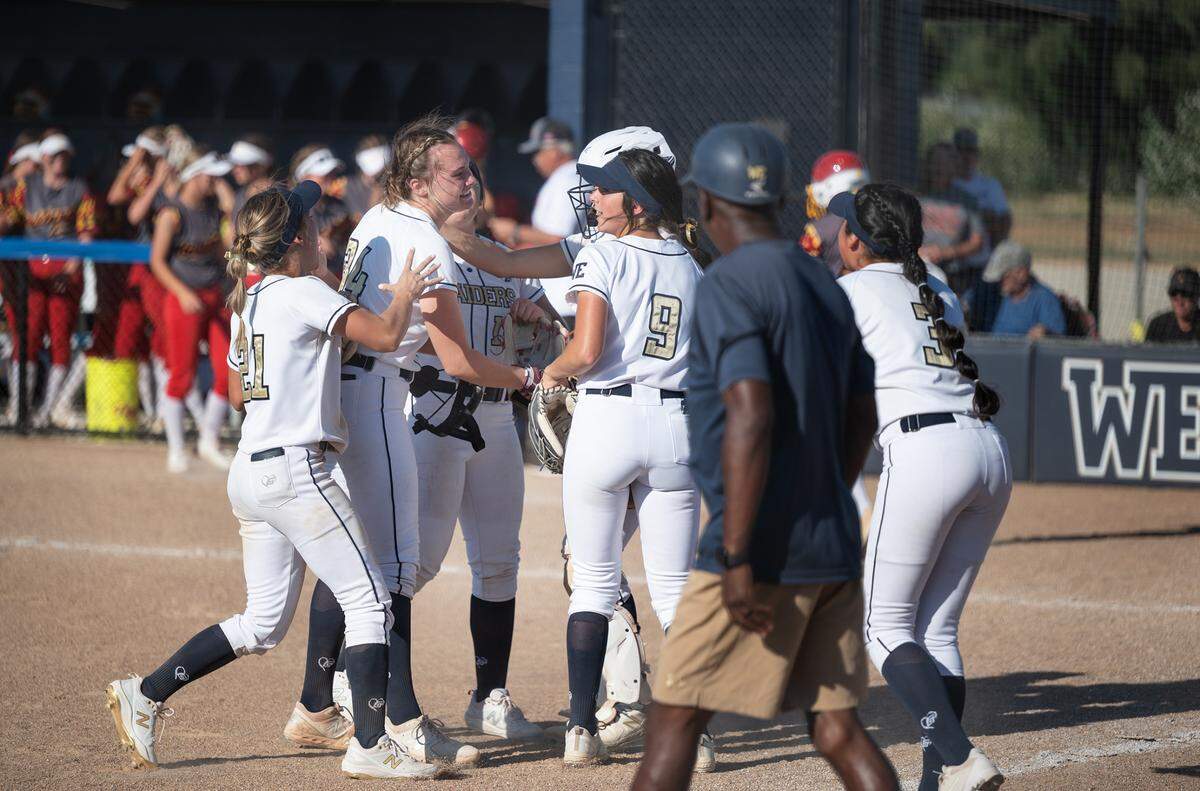 Central Catholic team members celebrate their 3-1 victory over Oakdale in the Sac-Joaquin Section Softball semifinal playoff game at Central Catholic High School in Modesto Calif., on Tuesday, May 24, 2022.