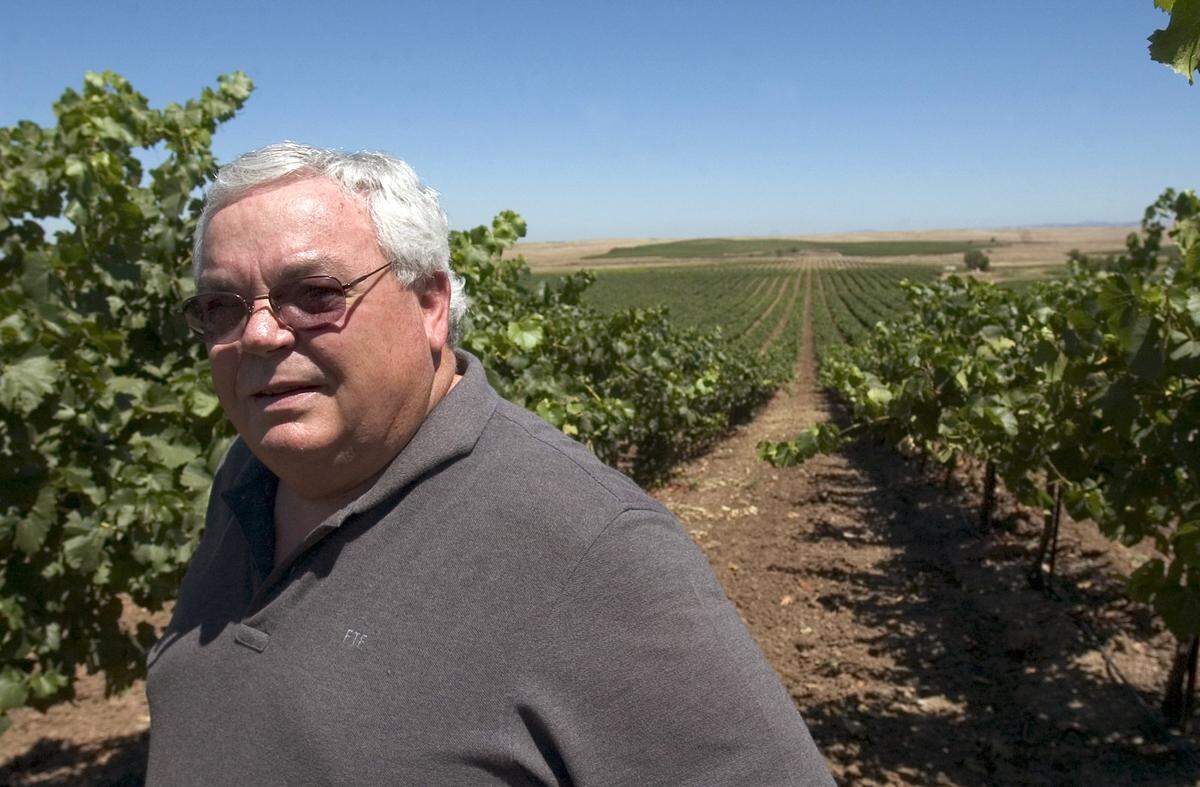 Fred Franzia, owner of the Bronco winery and the man behind the marketing concept of selling wine at $2 per bottle which earned him the nickname “Two Buck Chuck,” shows off some of his 6,000 acres of various varietals near the dismantled Rancho Seco nuclear power plant in Sacramento County on July 11, 2005.