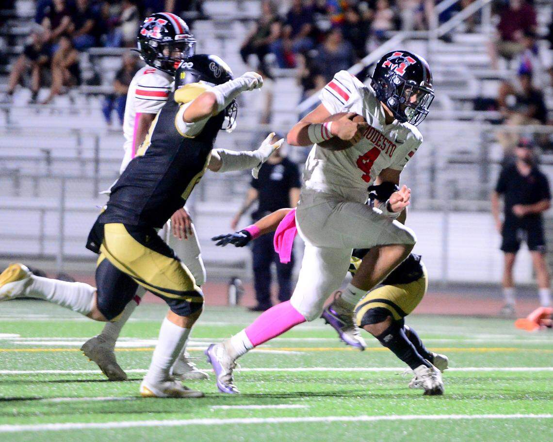 Modesto quarterback Israel Ceniceros (4) sprints into the end zone to score a touchdown during a game between Modesto High School and Enochs High School at Gregori High School in Modesto, CA on October 4, 2024.