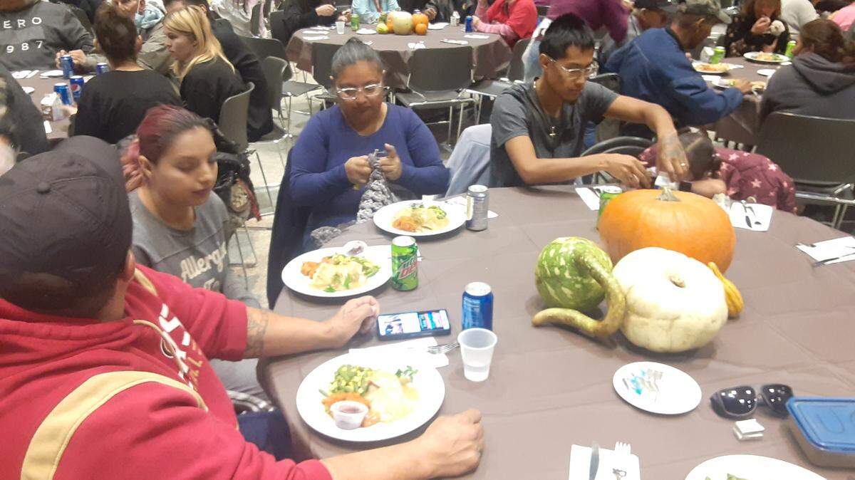 People eat at the free Thanksgiving meal at Modesto Centre Plaza on Nov. 24, 2022.