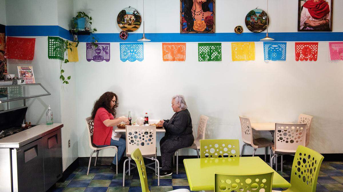 Wilma Dunkin, left, and Maria A Vargas, right, eat lunch at Taqueria Cardenas in Modesto, Calif., on Wednesday, March 24, 2021.