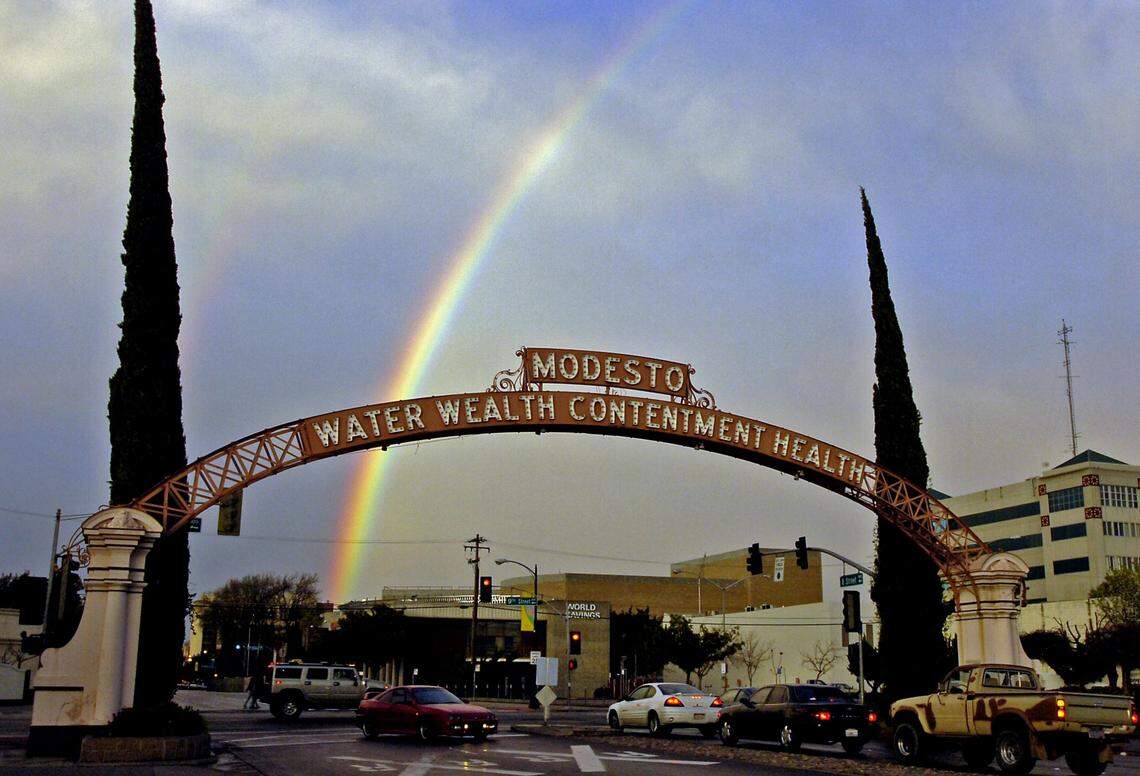 A rainbow appears alongside the Modesto Arch on Friday, April 7, 2006.  