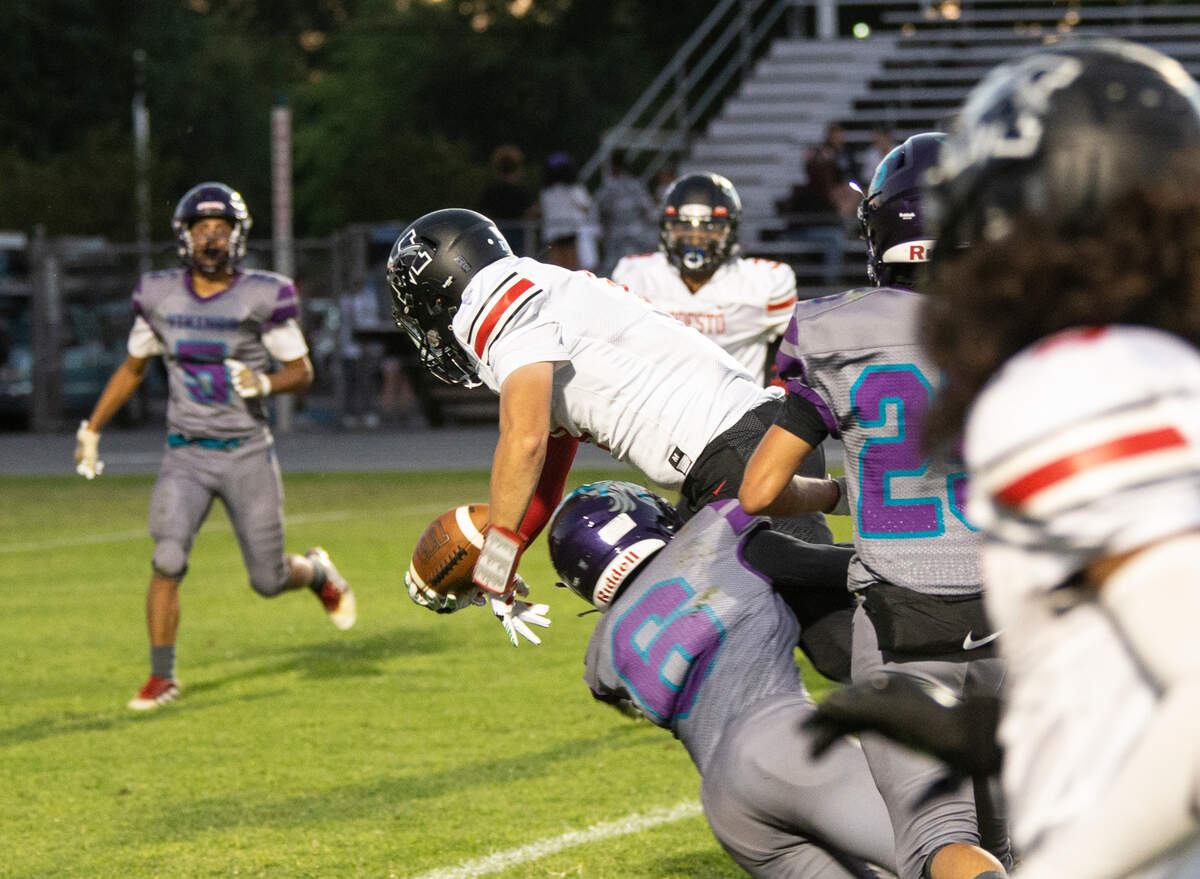 Heston Blom, 8, dives into the end zone for a touchdown with Johansen tries to hold him down Friday August 19, 2022 night.