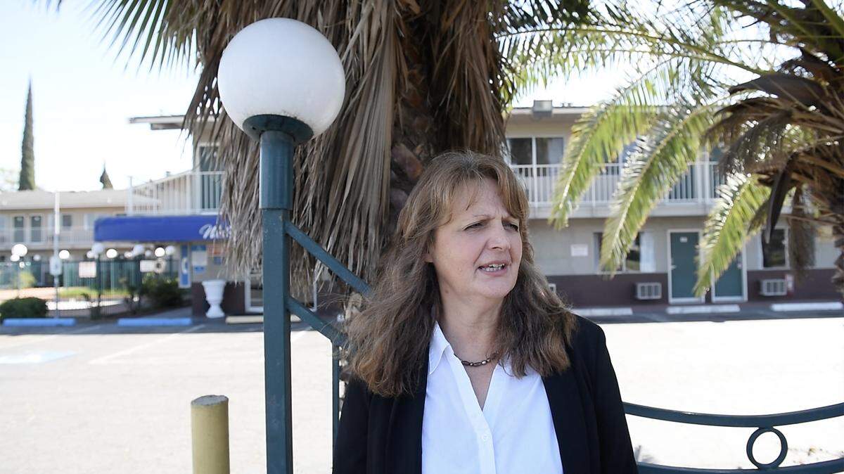 Housing Authority of the County of Stanislaus Executive Director Barbara Kauss speaks about the proposed purchase of the American Budget Inn and Suites on Kansas Avenue for use as transitional housing for homeless residents in Modesto, Calif., Thursday, Aug. 22, 2019.
