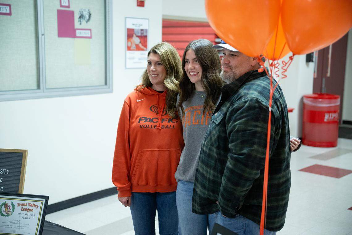 Adriana Dorn poses for pictures with her parents Jessica and Jared Dorn during a  signing ceremony at Ripon High School in Ripon, Thursday, Nov. 13, 2025. Dorn has signed to play volleyball at the University of the Pacific in Stockton. 