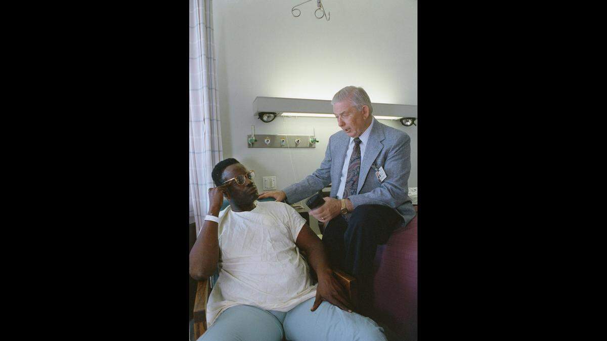 Memorial Hospital chaplain Adrian Condit with patient Ed Rosette on Aug. 2, 1991.