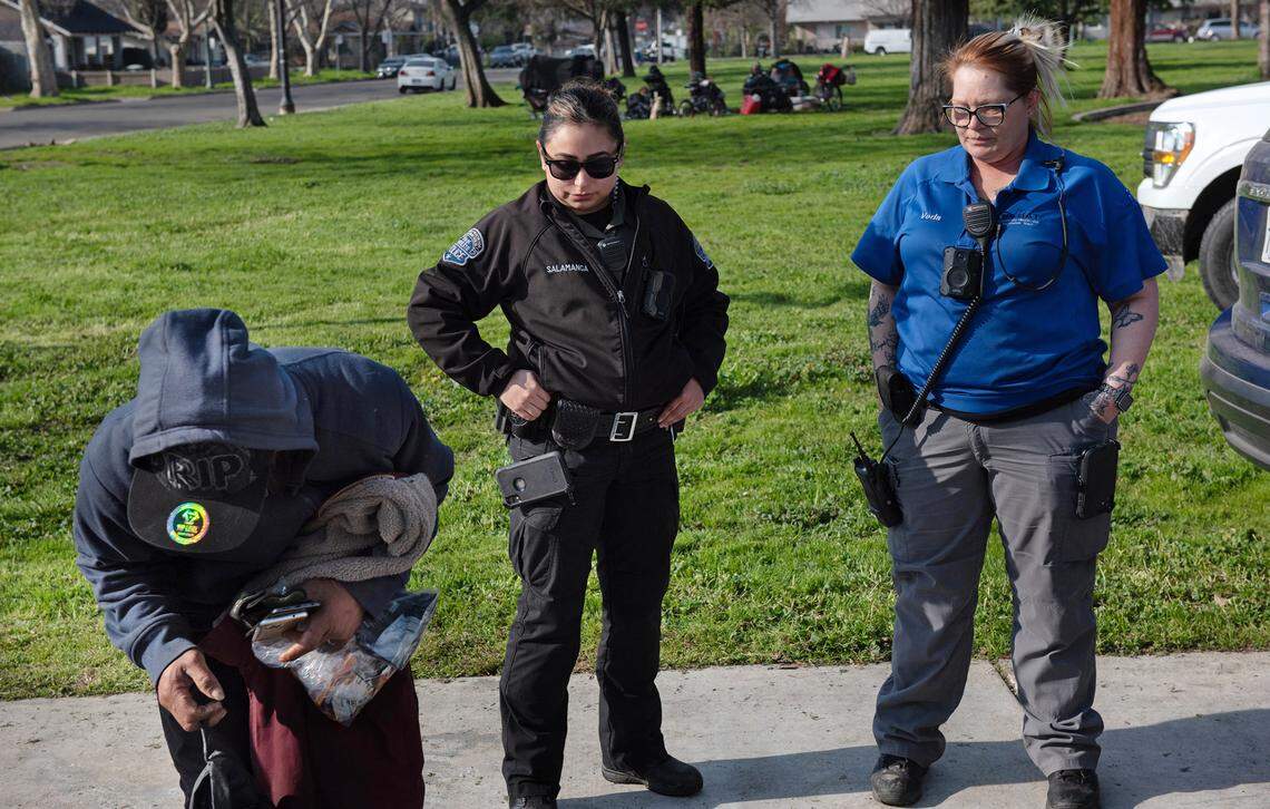 City of Modesto park ranger Ivonne Salamanca, and Community Health and Assistance Team (CHAT) outreach specialist Veda Malone arrange for a homeless man to go to the low-barrier shelter in Modesto, Calif., Friday, Jan. 27, 2023.