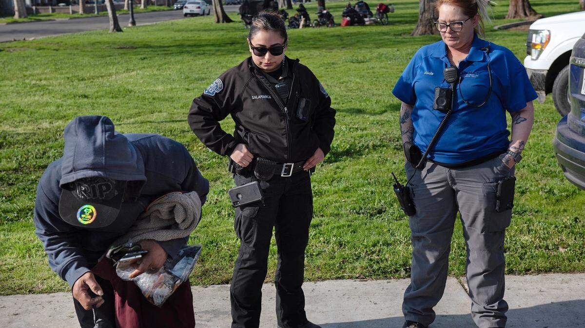 City park ranger Ivonne Salamanca and Community Health and Assistance Team outreach specialist Veda Malone arrange for a homeless man to go to the low-barrier shelter in Modesto, Calif., Friday, Jan. 27, 2023.