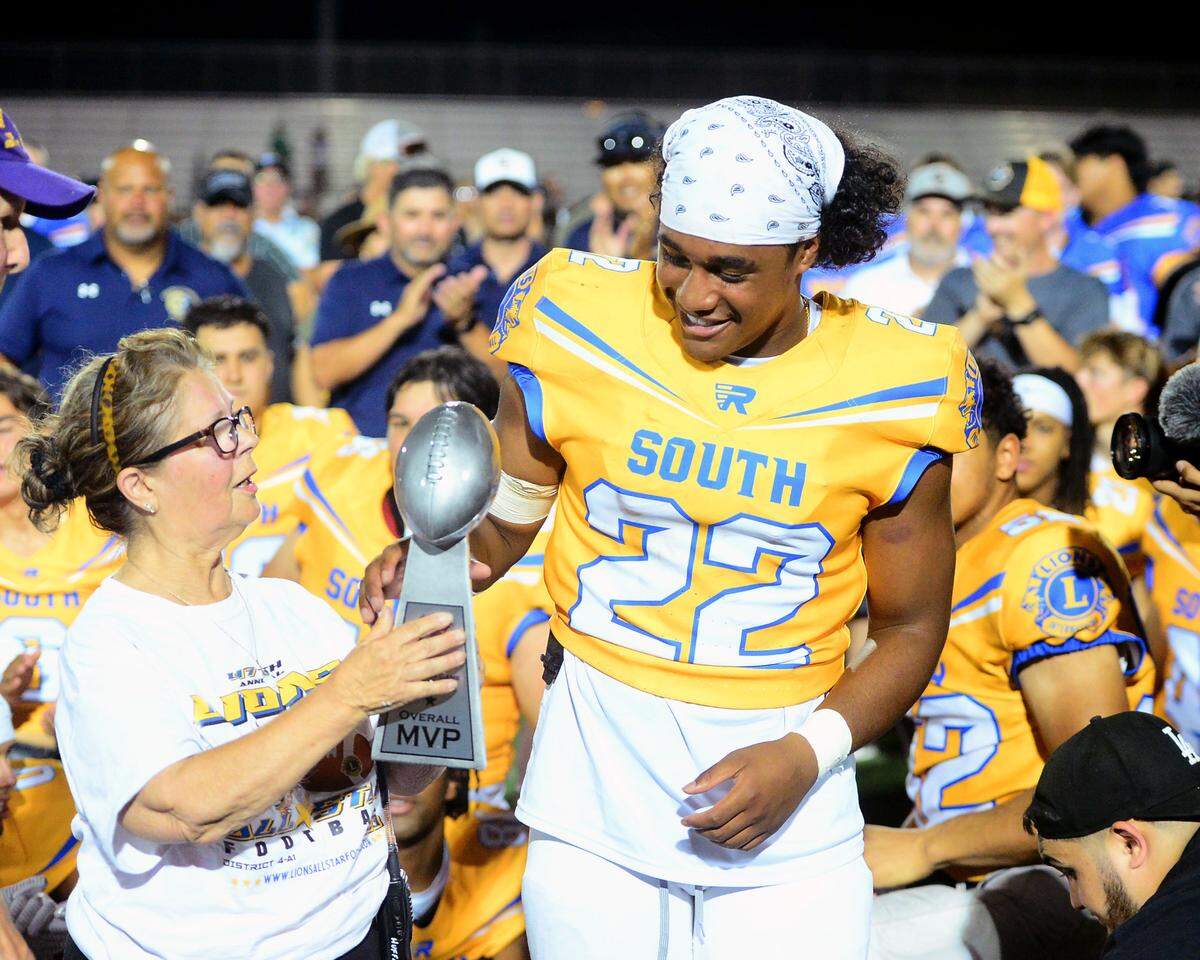 Enochs running back Aiden Muhammad (22) receives the MVP award after the 2024 Lions All-Star High School Football game at Tracy High School in Tracy, Calif. on June 22, 2024.