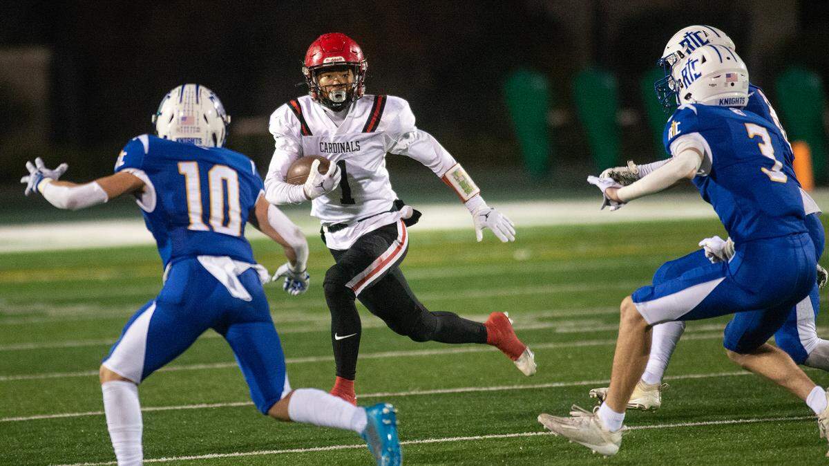 Woodland Christian’s Billy Hinkle runs into a trio of Ripon Christian defenders during the Sac-Joaquin Section Division VII championship game at St. Mary’s High School in Stockton on Friday.