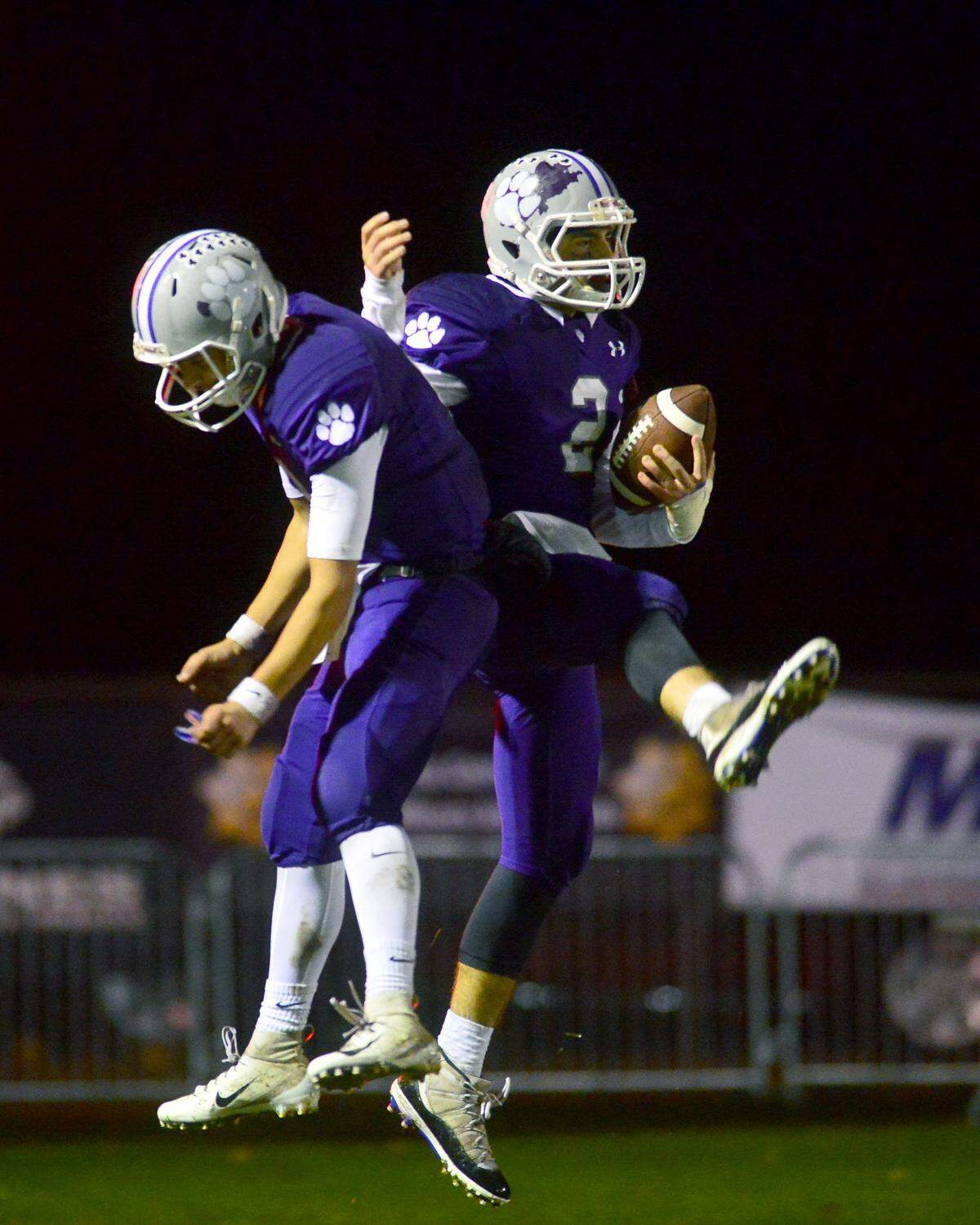 Denair players Drew Pritchard (right) and Elvis Silva (left) celebrate a touchdown during the CIF Division 7-AA championship game between Denair and Santee at Denair High School in Denair California on December 1, 2018.